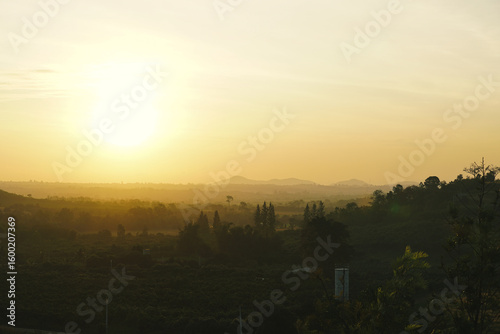 Sunrise in Khao Yai, Thailand. Majestic sunrise over the mountains. Colorfull sunrise on foggy day over Tipperary mountains and fields. Beautiful sunshine at misty morning mountains.