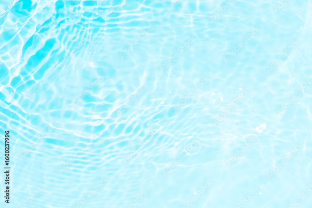 Obraz premium Blue water with ripples on the surface. Defocus blurred transparent blue colored clear calm water surface texture with splashes and bubbles. Water waves with shining pattern texture background.