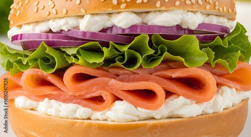 A highly detailed and sharply focused shot of a delicious sesame salmon bagel sandwich.
