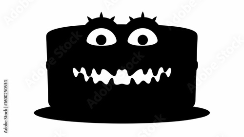 A whimsical black cake with large white eyes and a toothy grin, set against a plain white background