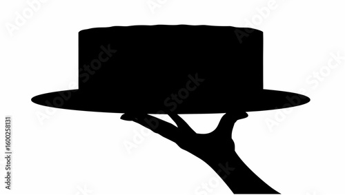 Silhouette of a hand holding a black top hat presented on a platter against a white background image view