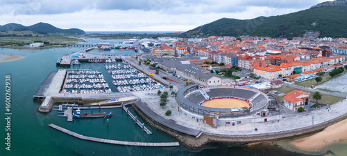 Aerial view from a drone of the Santoña bullring and fishing port. Santoña, Victoria, and Joyel Marshes Natural Park. Cantabrian Sea. Cantabria. Spain. Europe.