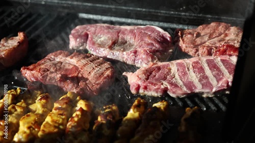 Cooking beef steak Juicy gill steak sizzling on an open flame grill with smoke