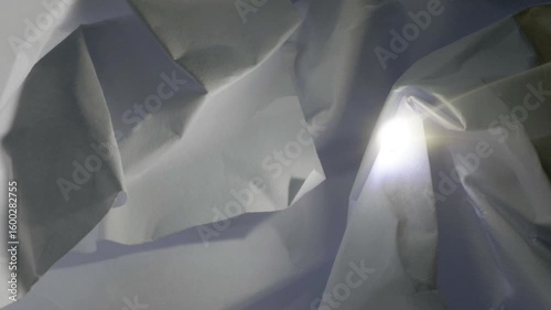Burning paper with the Sun and a magnifying glass.
The Sun focussed on crumpled paper which starts to burn. 