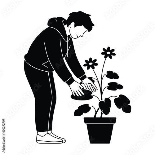 Person watering a potted plant with flowers