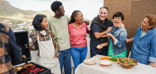 Fotografija Multigenerational people doing barbecue at home's rooftop - Multiracial friends