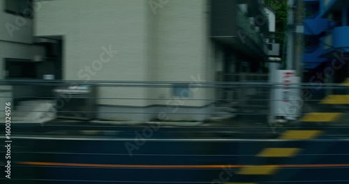 Wallpaper Mural View from a train window while driving down a street in Tokyo Torontodigital.ca