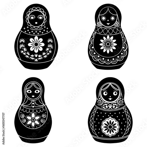 Four black and white matryoshka dolls with floral and decorative patterns in a symmetrical arrangement