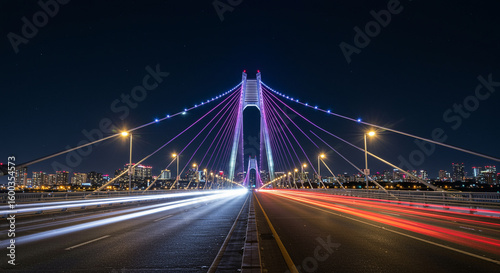 Modern Suspension Bridge Night Lights.
Modern cable-stayed bridge illuminated with purple lights at night, long exposure with cityscape and traffic trails.

