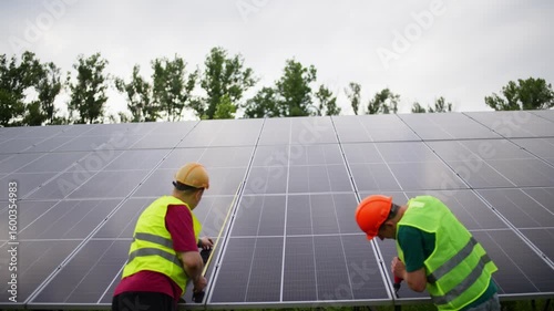 Engineers working on installation and setup of solar power plant. Green eco energy, solar panels in homes, environmental protection. High quality 4k footage
