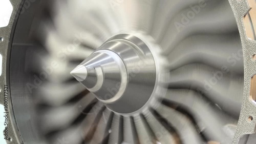 Aircraft engine turbine printed on a 3D printer spinning rapidly in an industrial setting