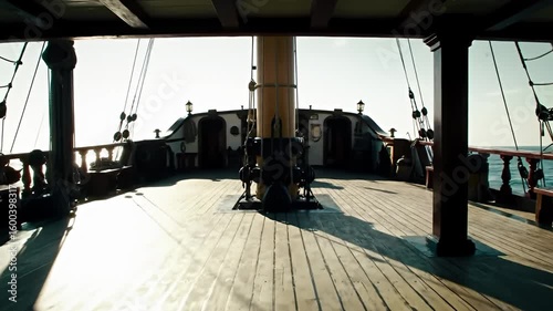 Looking along the aged wood deck of a tall ship towards the horizon on a sunny day