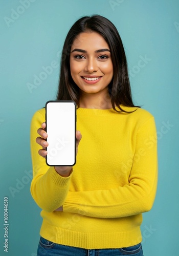 young woman holding a blank card, Young Indian woman presents blank smartphone screen. Happy girl shows device with empty display. Modern tech, app, design, advertising concept. Female holds mobile ph