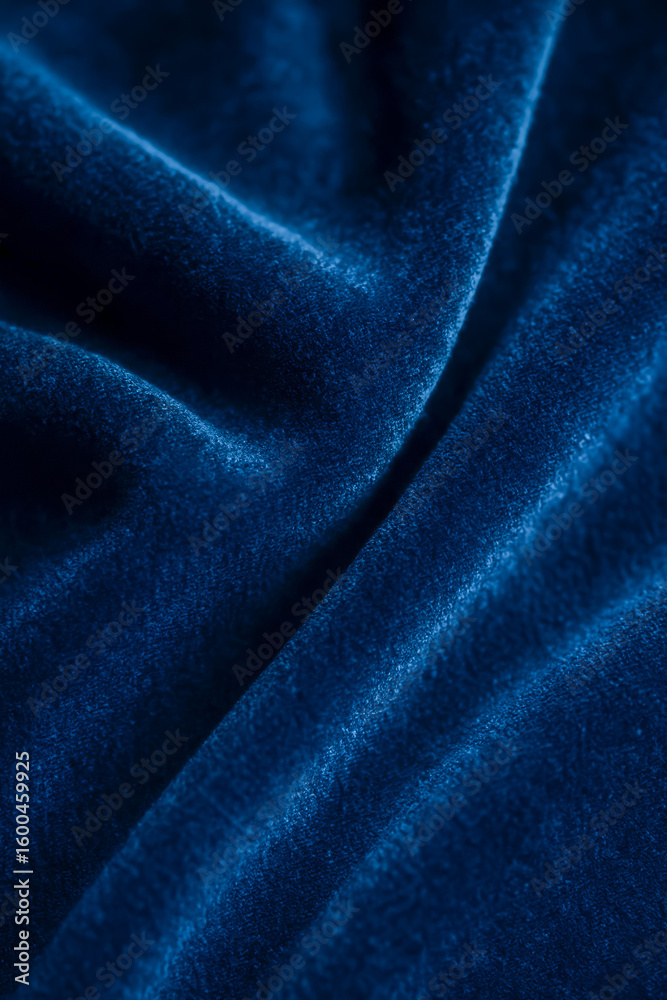 Obraz premium Close-up of textured deep blue velvet fabric draped elegantly
