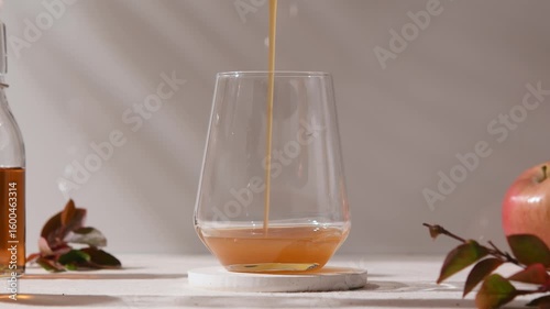 Step-by-step making of iced maple apple latte: syrup poured, ice cubes added, milk flows in, espresso completes layered drink.