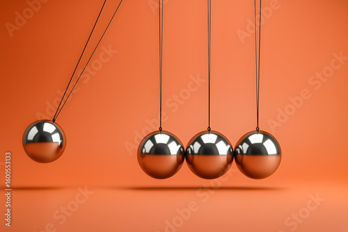 Newton's Cradle Demonstrating Kinetic Energy Transfer on Bright Orange Background for Physics and Motion Concepts