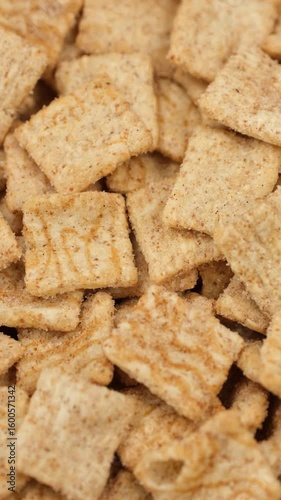Heap of squares breakfast cereal top view, rotate