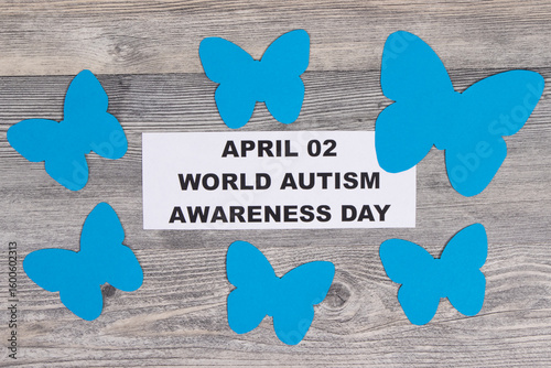 Blue shapes of butterflies and inscription April 02 World Autism Awareness Day. Symbol of Autism Spectrum Disorder