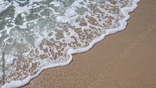 Soft white foam patterns forming on shallow waves near the shore