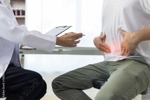 Obraz na płótnie Man with abdominal pain, bloating, diarrhea goes to the doctor at medical clinic