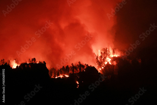 The Palisades fire burns fiercely during a powerful windstorm, spreading devastation across the west side of Los Angeles, California.