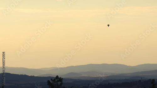 Hot air ballon fly above hill silhouette. Czech landscape, leisure activity