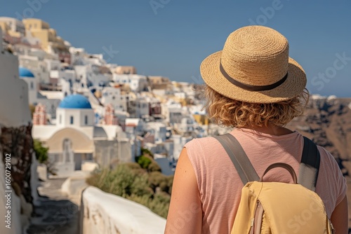 Tourist admiring Oia town in Santorini, Greece