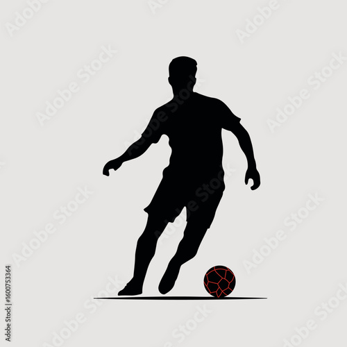 Silhouette of a soccer player dribbling a ball