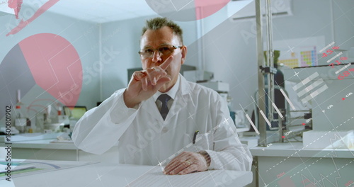Pointing scientist wearing lab coat raising finger at digital display in lab, showing data overlays