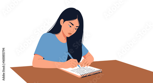 Focused student handwriting in a notepad while sitting at a brown desk with concentration evident on her face