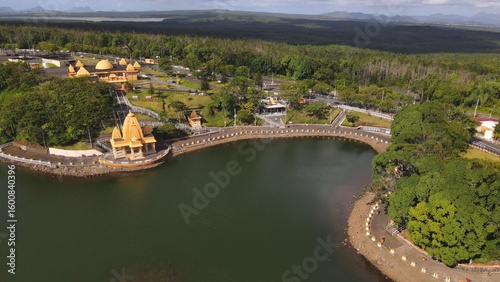 Bild auf Leinwand Drone photo of Ganga Talao temple complex nestled around a volcanic crater lake in Mauritius, a revered Hindu pilgrimage site surrounded by forest