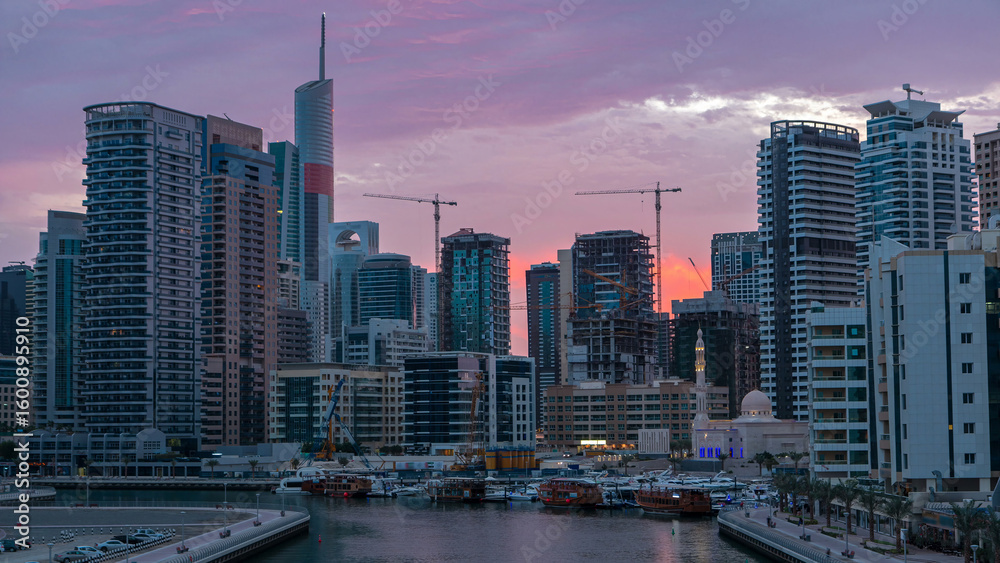 Fototapeta premium Dubai Marina towers and canal in Dubai night to day timelapse