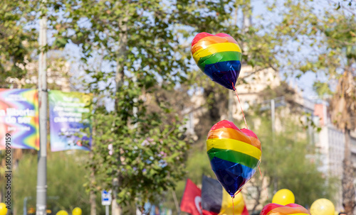 Photography Heart-shaped balloons in rainbow colors create a festive atmosphere as people gather to celebrate Pride in Barcelona