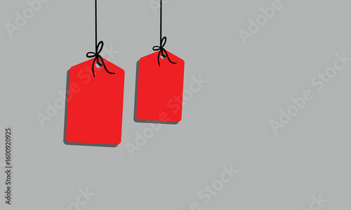 White rectangular tag with rounded corners hanging from a string with a bow on a soft background