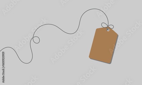 White rectangular tag with rounded corners hanging from a string with a bow on a soft background