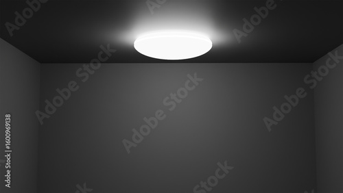 Modern ceiling lamp, glowing round light fixture on dark ceiling in empty room with gray walls, minimalist interior