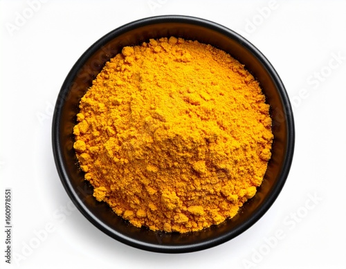 Golden Turmeric Powder in Black Bowl Top View.