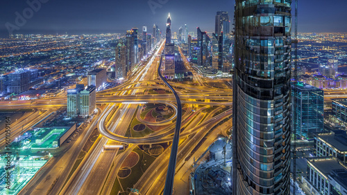 Scenic Dubai downtown skyline at night timelapse. Rooftop view of Sheikh Zayed road with numerous illuminated towers.