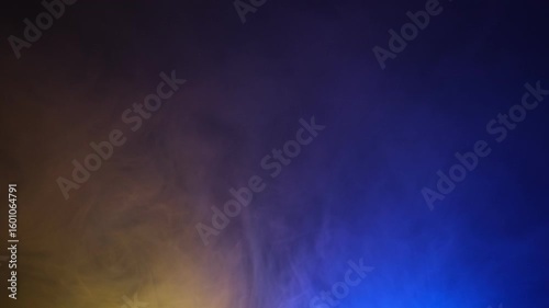 Abstract background of yellow and blue smoke gradient slow motion