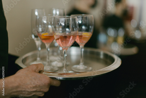 Wallpaper Mural Waiter serves refreshing cocktails on a silver tray at upscale event venue during evening gathering Torontodigital.ca