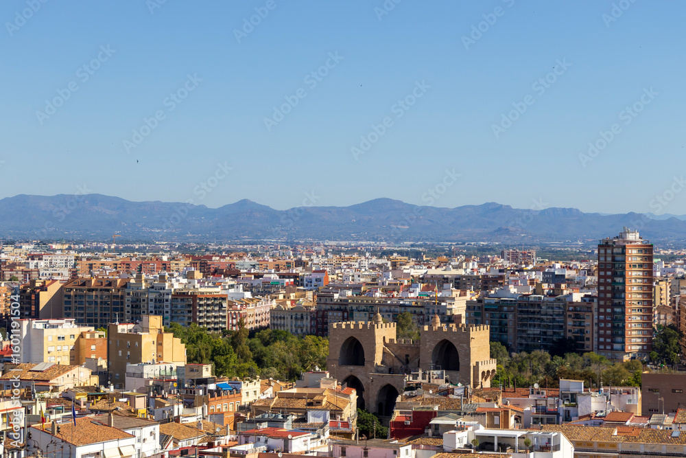 Aerial view of Valencia featuring urban landscapes and the iconic Torres de Serranos. The scene captures the vibrant city life under clear blue skies, perfect for travel themes. Aerial view of Valencia featuring urban landscapes and the iconic Torres de Serranos. The scene captures the vibrant city life under clear blue skies, perfect for travel themes.