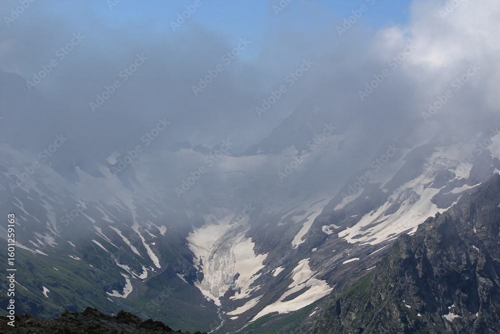 Fototapeta premium mountain peaks in the clouds North Caucasus Dombay Elbrus region midsummer