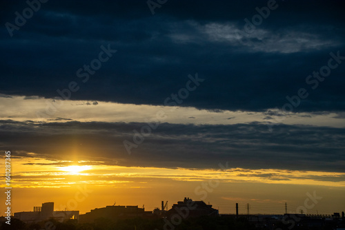 Sunset silhouettes at oil refinery Detroit Michigan 