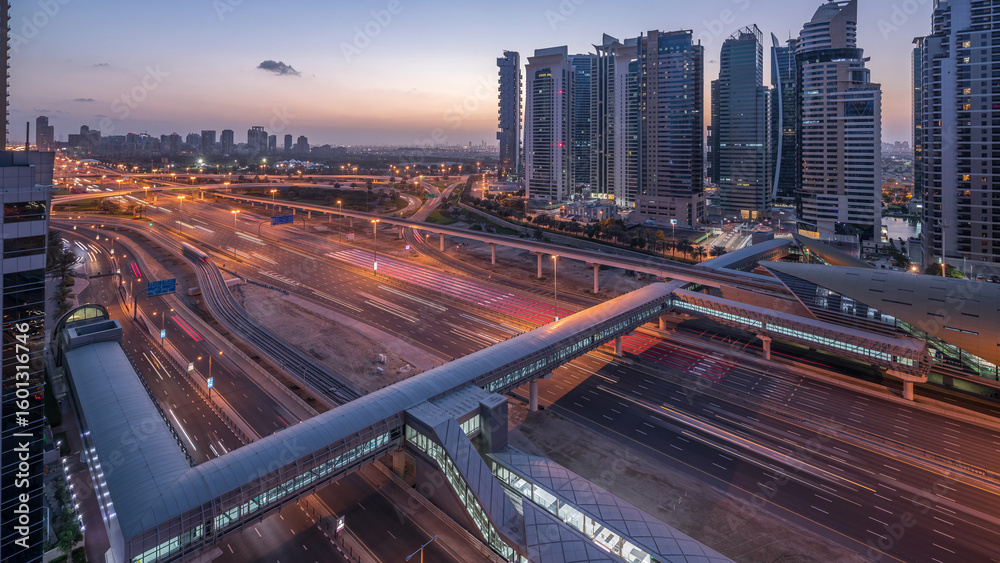 Fototapeta premium Aerial top view to Sheikh Zayed road near Dubai Marina and JLT night to day timelapse, Dubai.