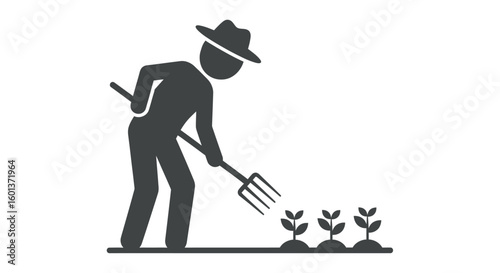 Silhouette of a farmer wearing a hat, tending to young plants with a pitchfork in a field.
