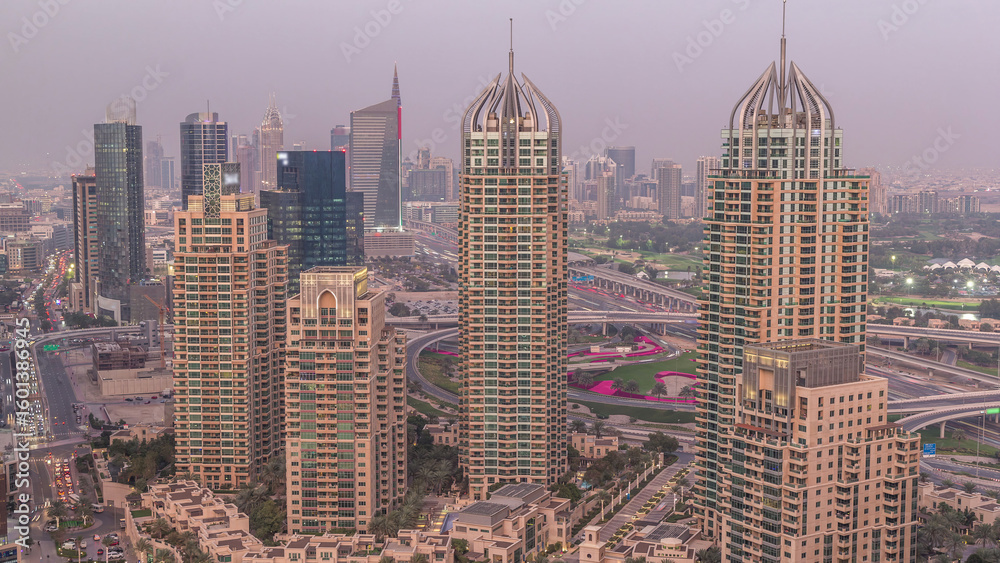 Obraz premium Aerial top view of Dubai Marina day to night timelapse. Modern towers and traffic on the road