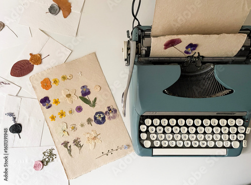 vintage typewriter with old paper and flowers