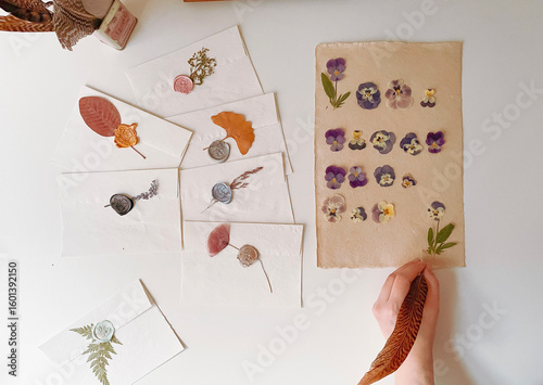 hand holding a notebook with flowers, 