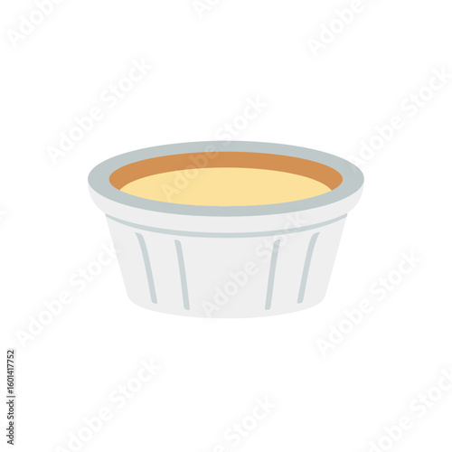 Custard dessert in a white ramekin dish isolated on a white background.