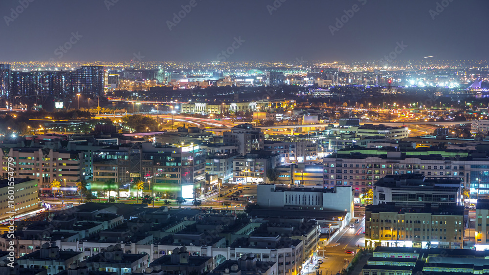 Naklejka premium Aerial view of neighborhood Deira with typical buildings night timelapse, Dubai, United Arab Emirates